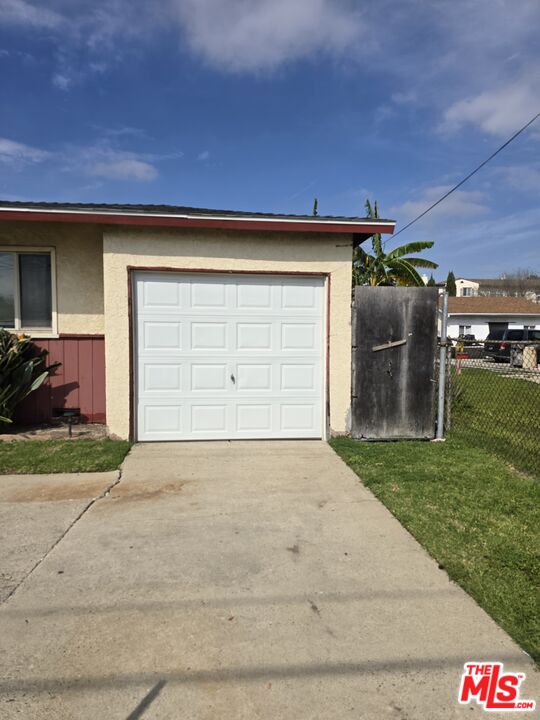 563 East 223rd Street Carson, CA 90745 - Photo 3 of 6 a front view of a house with a yard and garage