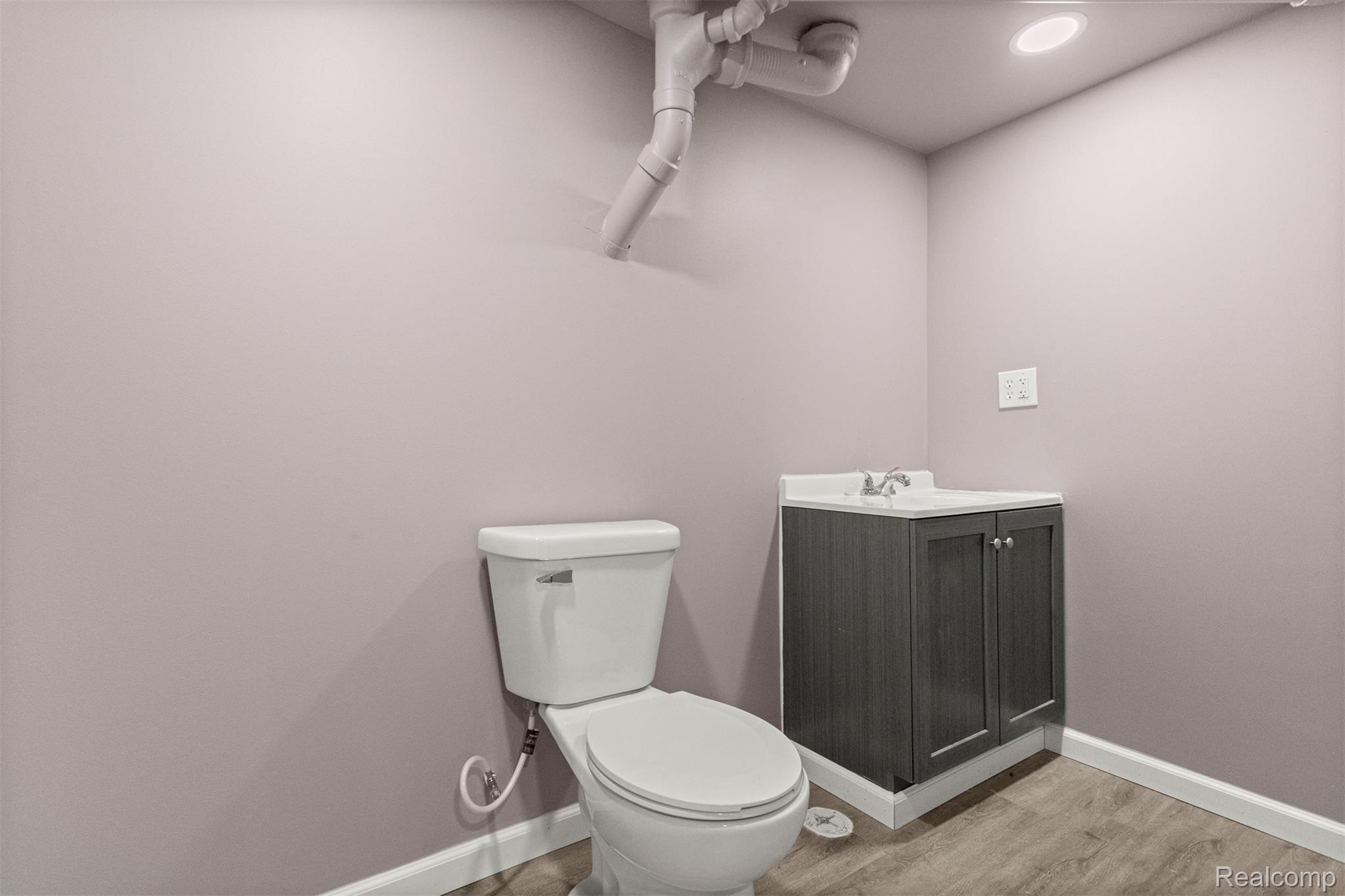 15705 Champaign Road Allen Park, MI 48101 - Photo 29 of 42 Half bath featuring vanity, light wood-style floors, and recessed lighting