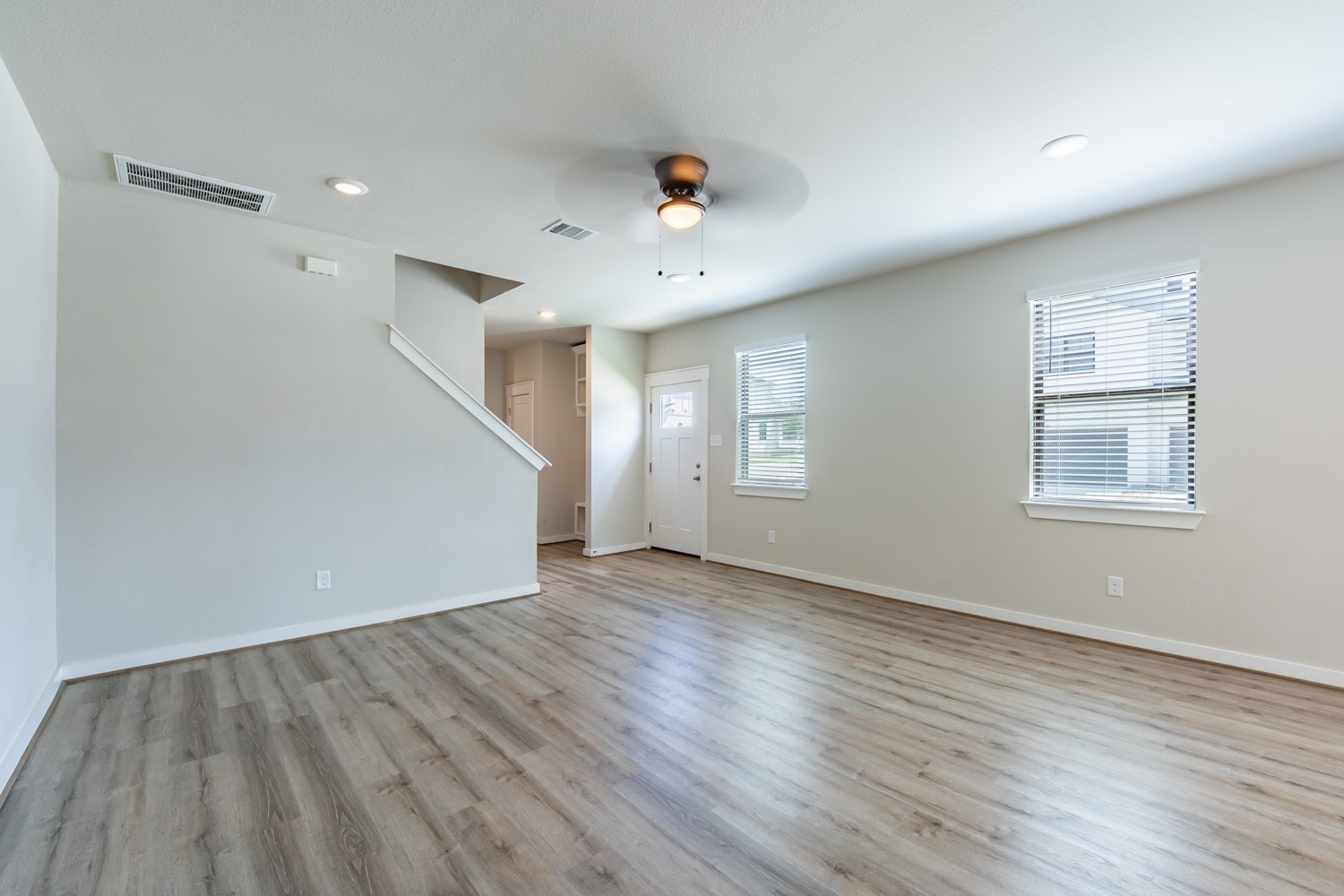 147 Waterside Road, Unit A Buda, TX 78610 - Photo 6 of 27 A generous living area featuring resilient wood flooring and plentiful natural light.