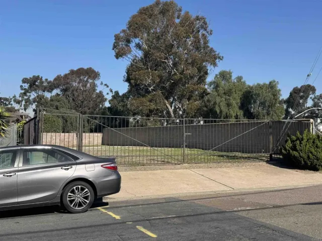 a view of street with a cars parked on road