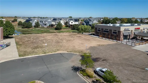 an aerial view of a house with a yard basket ball court and outdoor seating