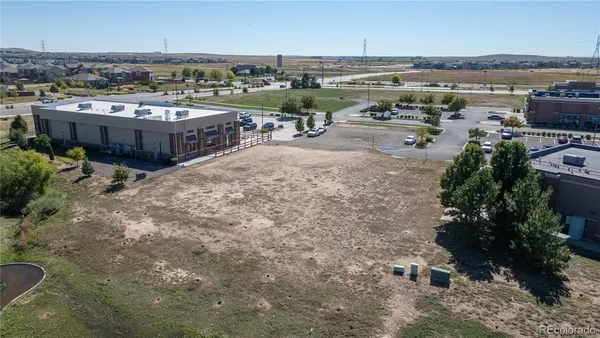 an aerial view of a house with a yard basket ball court and outdoor seating