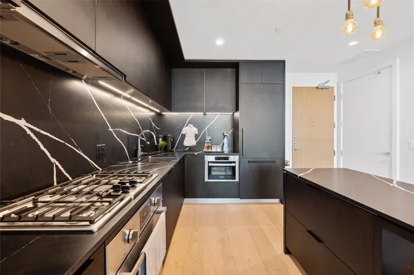 a kitchen with a stove and a refrigerator