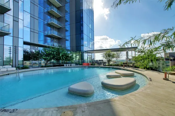 a view of a lake with couches chairs and city view