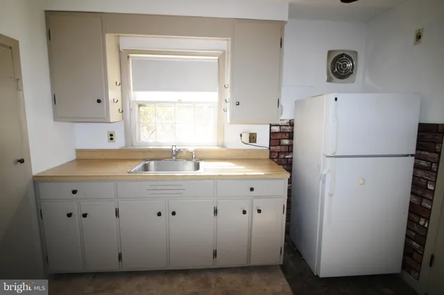 a kitchen with a sink and cabinets