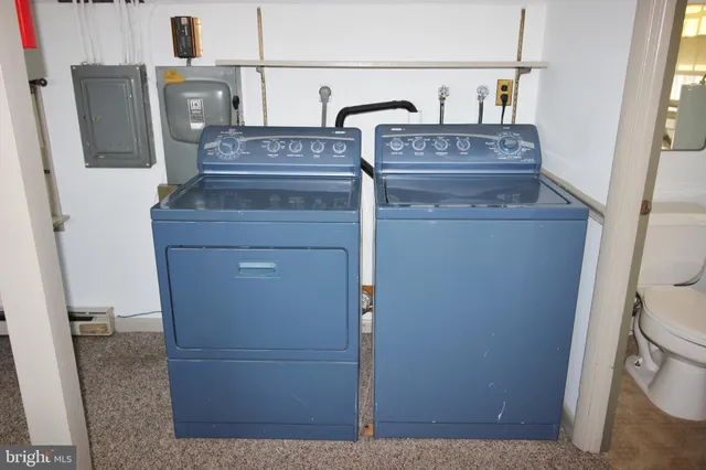 a view of a hallway with storage and utility room