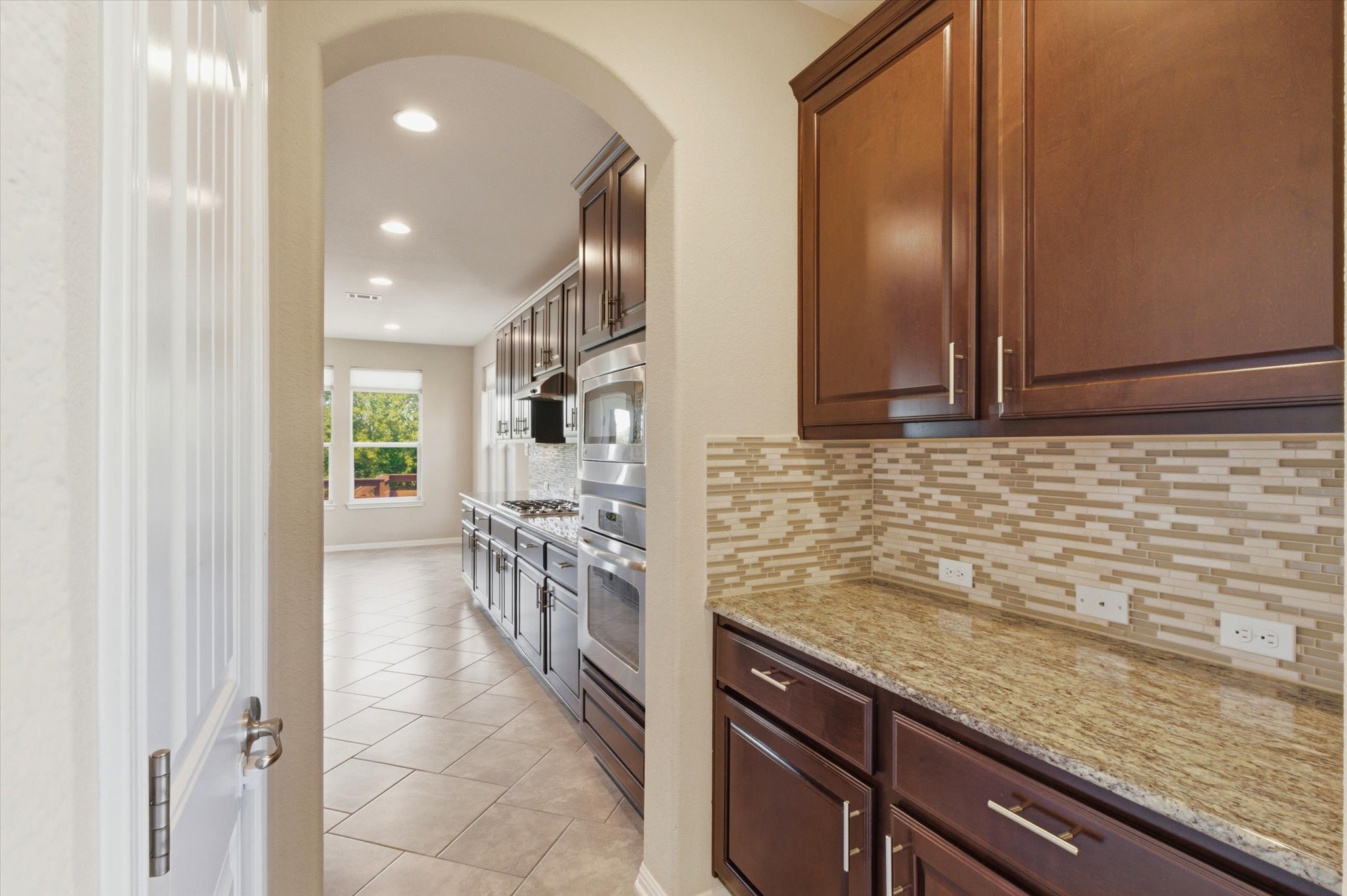 1511 Rimstone Drive Cedar Park, TX 78613 - Photo 8 of 39 A well-equipped kitchen showcasing a gas cooktop, built-in oven, and elegant cabinetry.