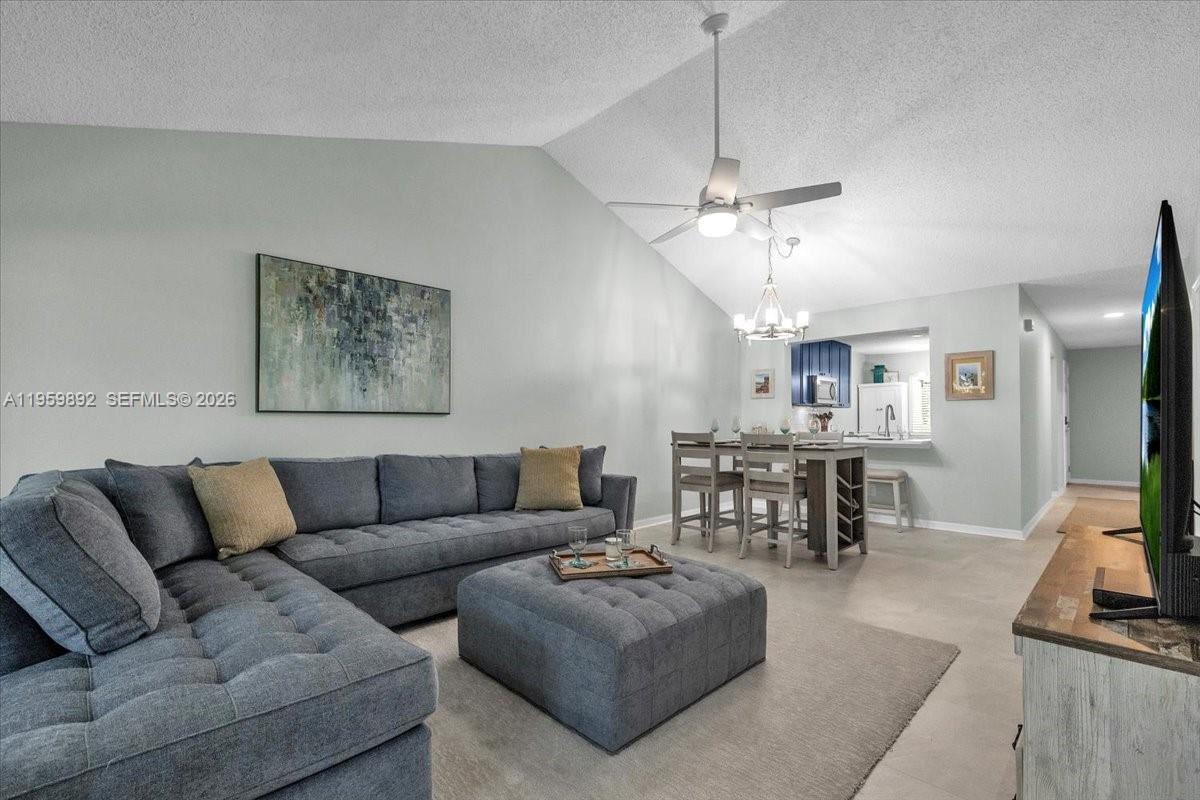 a living room with furniture a dining table and a fireplace