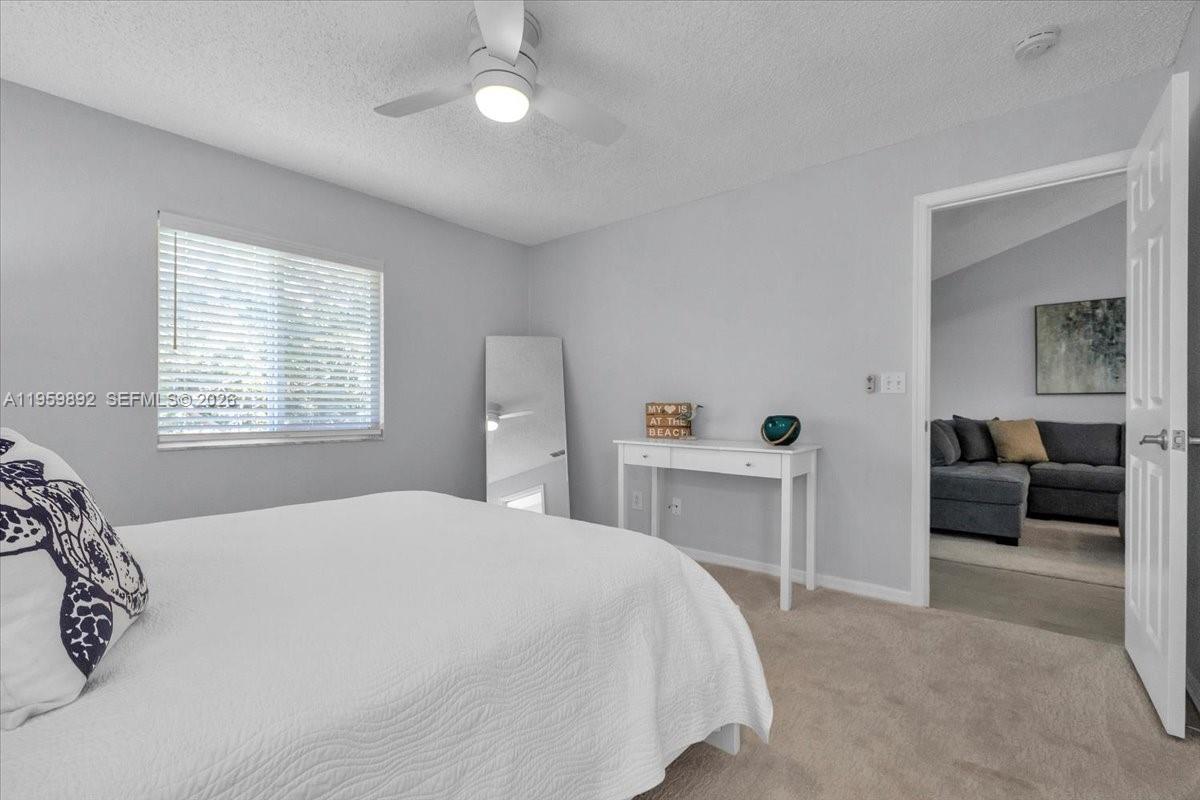 280 Timber Lake Circle, Unit 201 Naples, FL 34104 - Photo 13 of 34 a bedroom with a bed and a couch