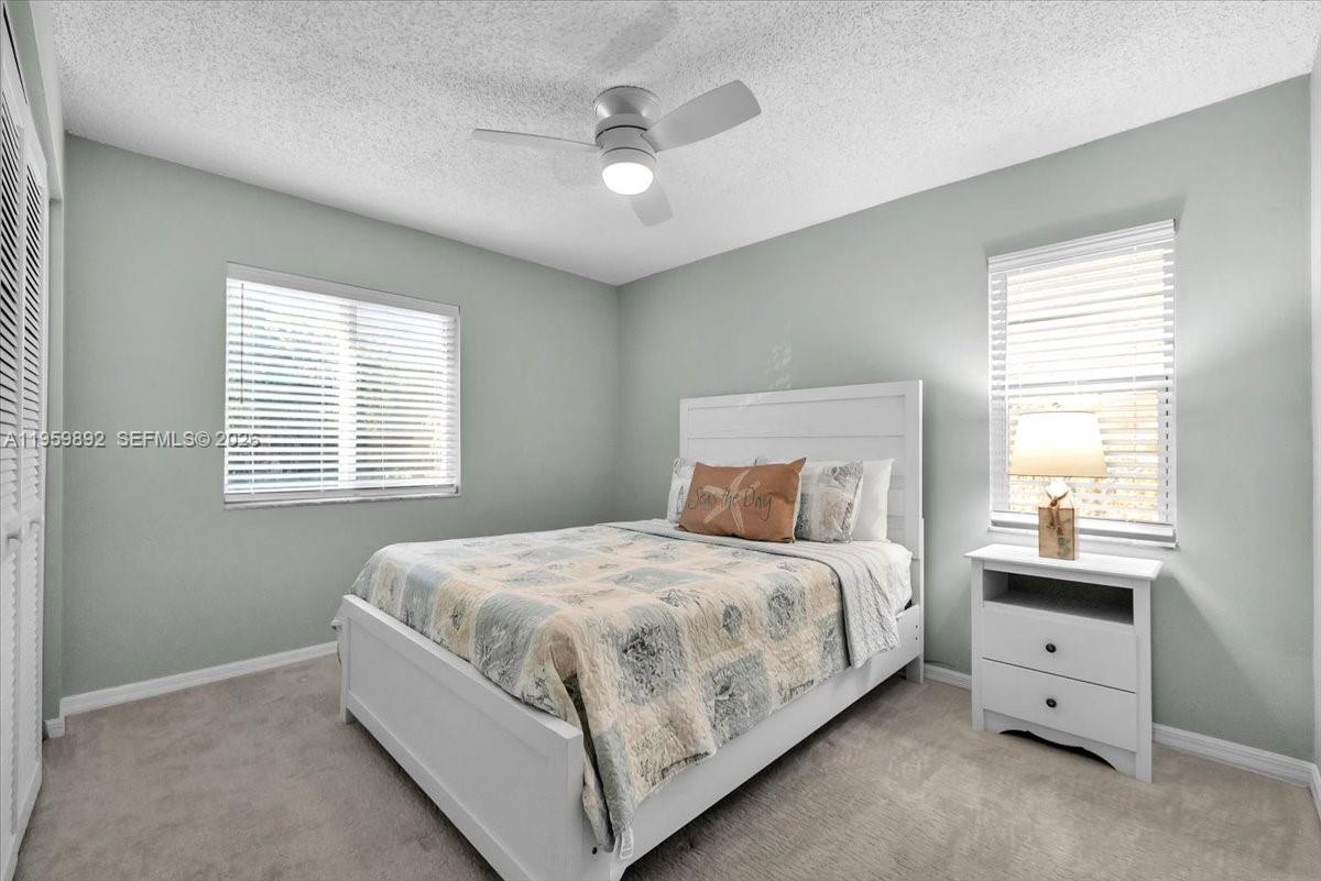 280 Timber Lake Circle, Unit 201 Naples, FL 34104 - Photo 15 of 34 a bedroom with a bed and a window