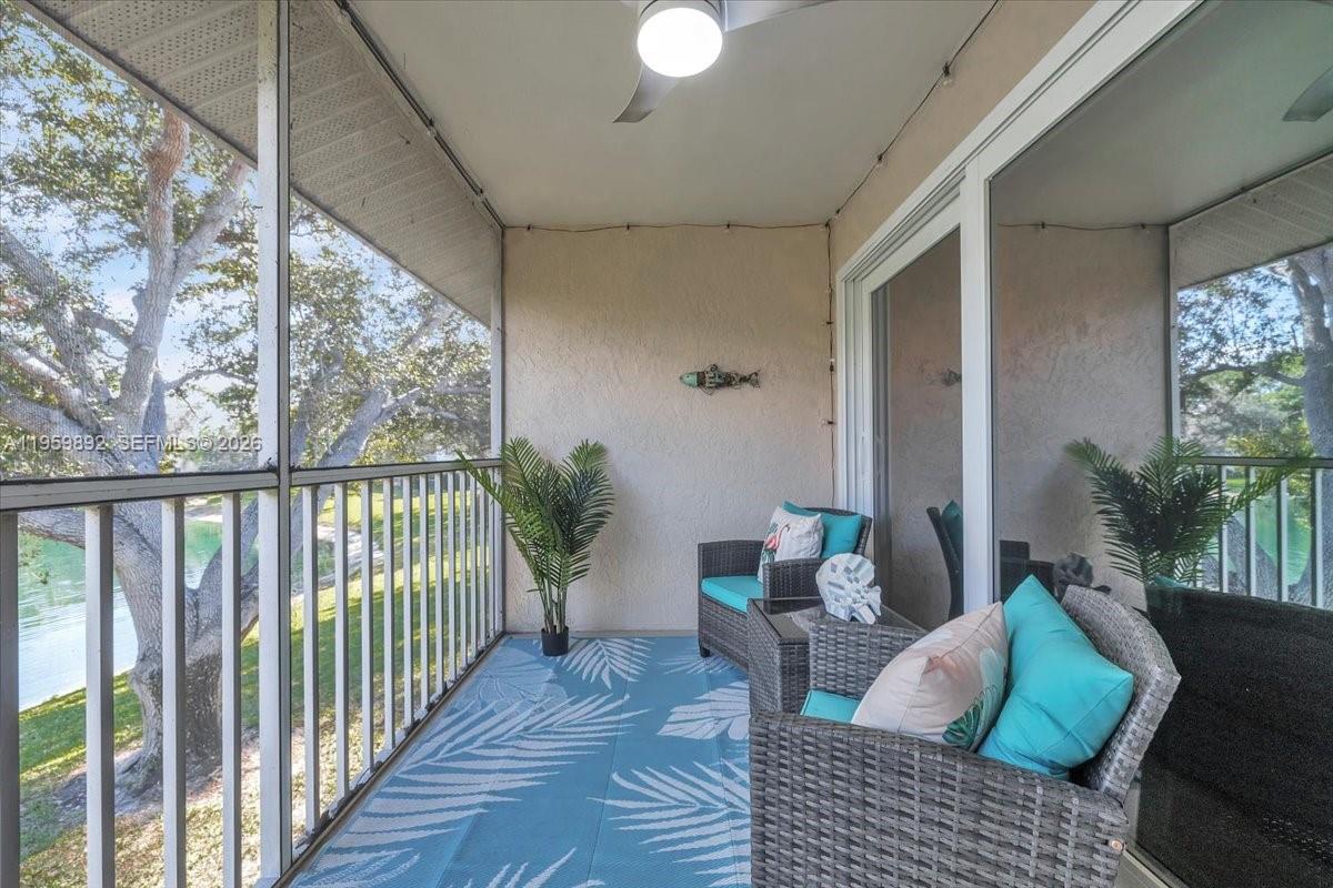 280 Timber Lake Circle, Unit 201 Naples, FL 34104 - Photo 22 of 34 a living room with furniture and a floor to ceiling window