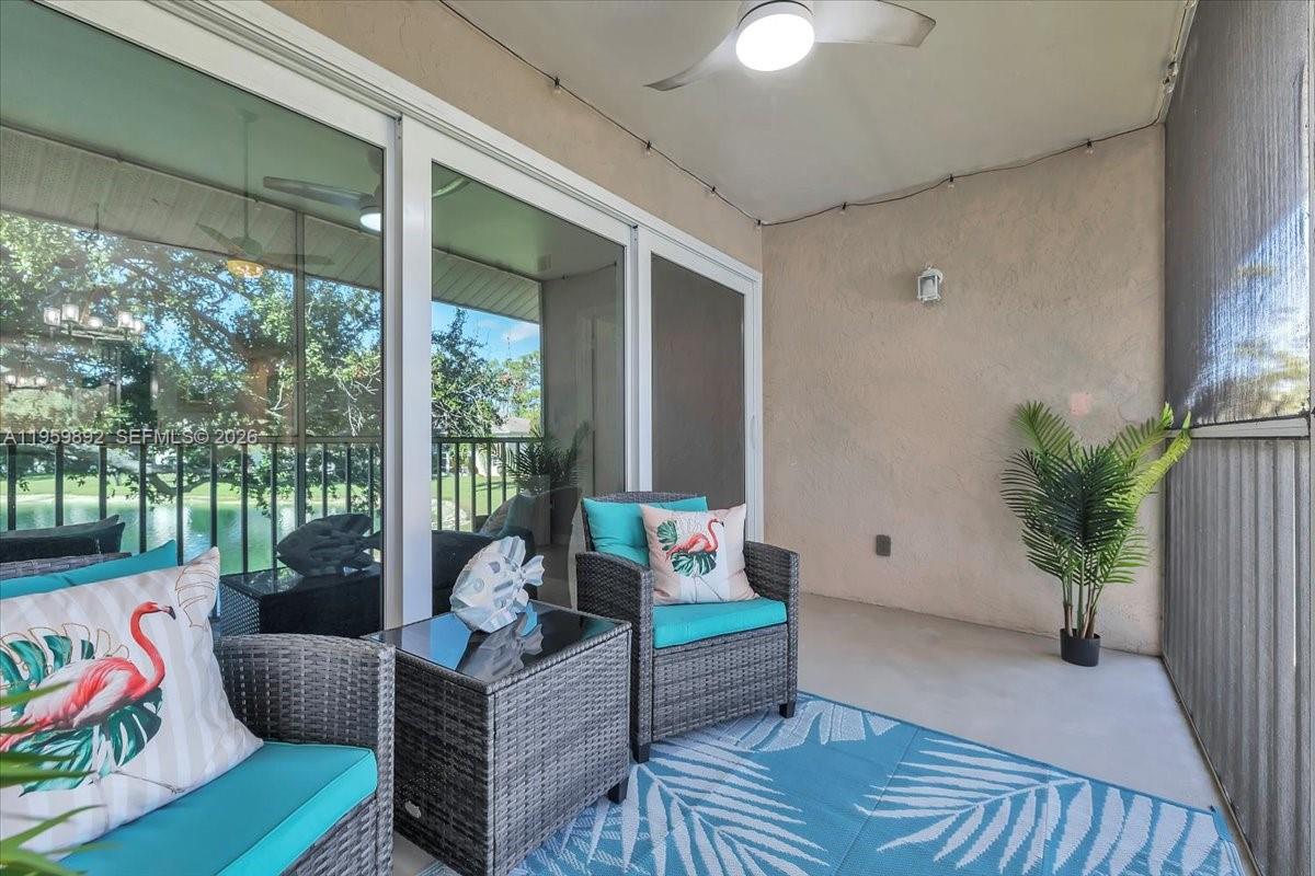 280 Timber Lake Circle, Unit 201 Naples, FL 34104 - Photo 23 of 34 a living room with furniture and a potted plant