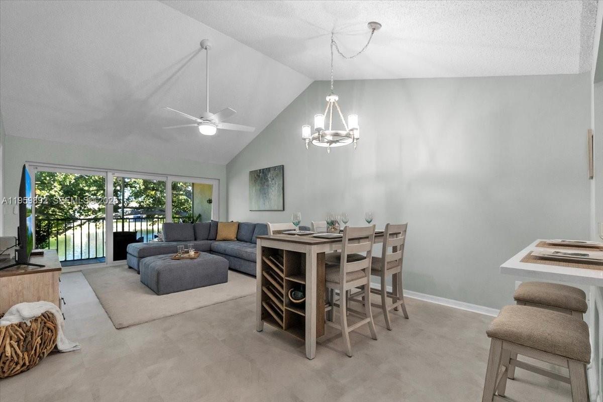 280 Timber Lake Circle, Unit 201 Naples, FL 34104 - Photo 3 of 34 a view of a livingroom with furniture window and outside view