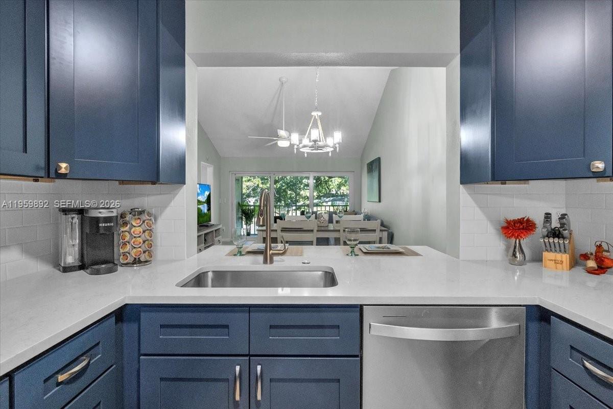 280 Timber Lake Circle, Unit 201 Naples, FL 34104 - Photo 9 of 34 a kitchen with a sink and cabinets