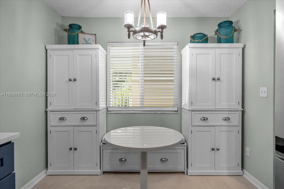 280 Timber Lake Circle, Unit 201 Naples, FL 34104 - Photo 10 of 34 a view of cabinets with wooden floor