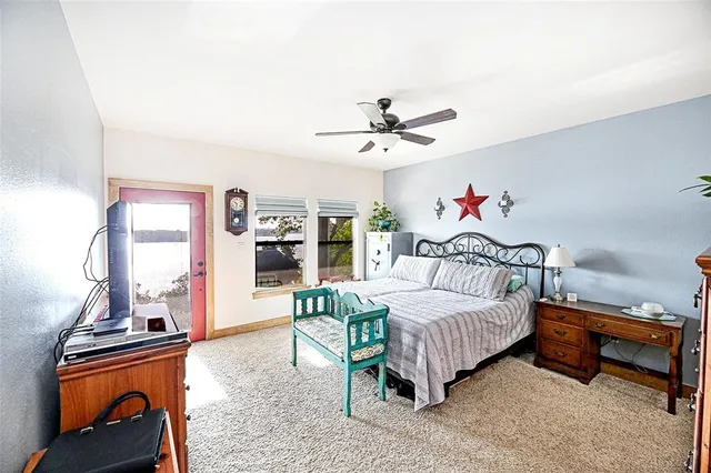 a bed room with a bed furniture and a flat screen tv