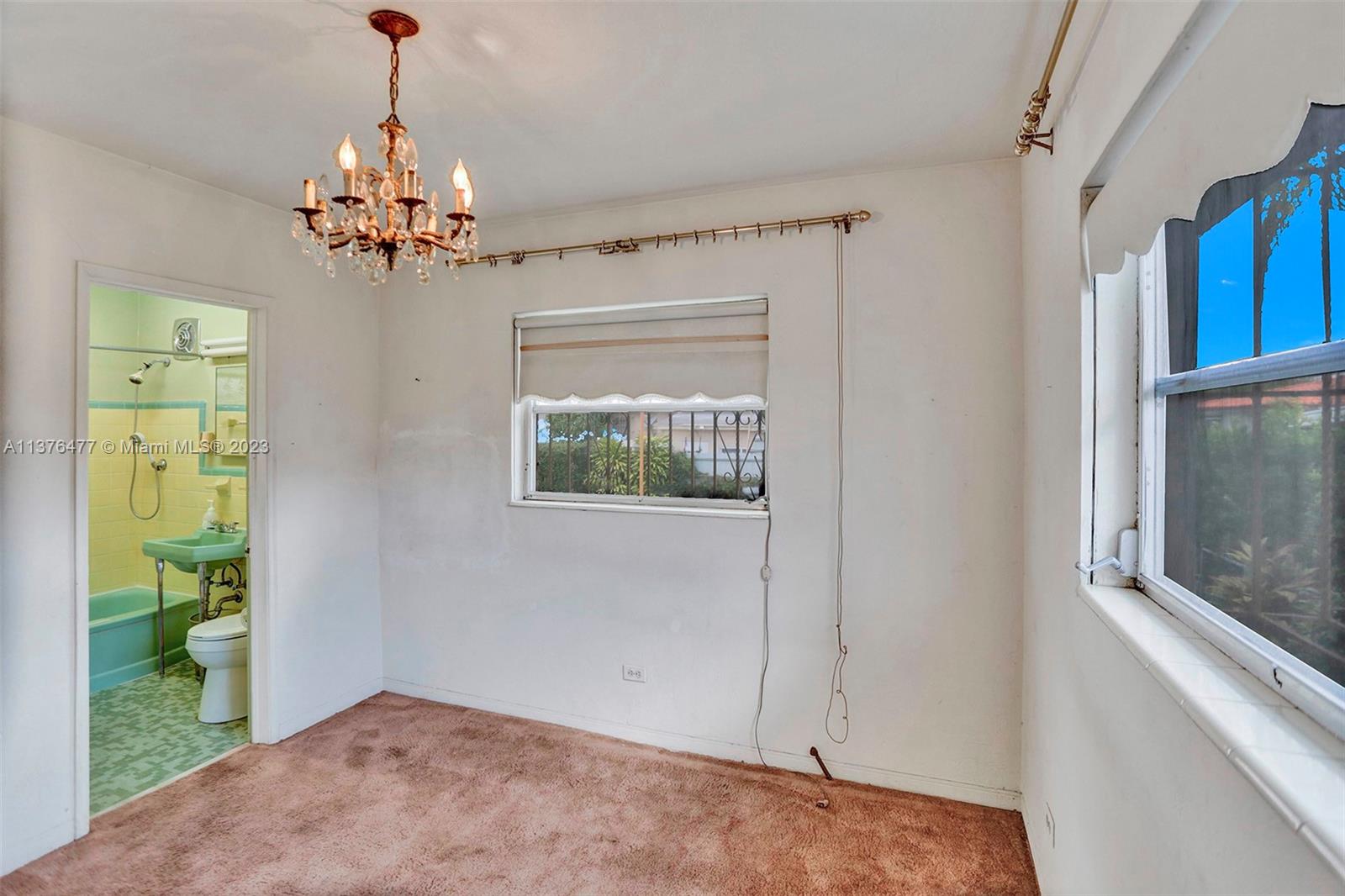 5171 Southwest 6th Street Miami, FL 33134 - Photo 25 of 45 a view of a bedroom with a window and chandelier