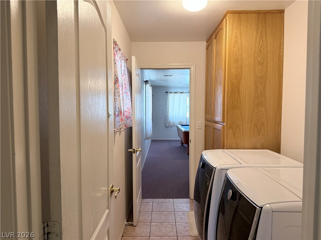 1220 East Gamebird Road Pahrump, NV 89048 - Photo 9 of 49 Functional utility space with built-in cabinetry, providing convenient storage and laundry appliances.