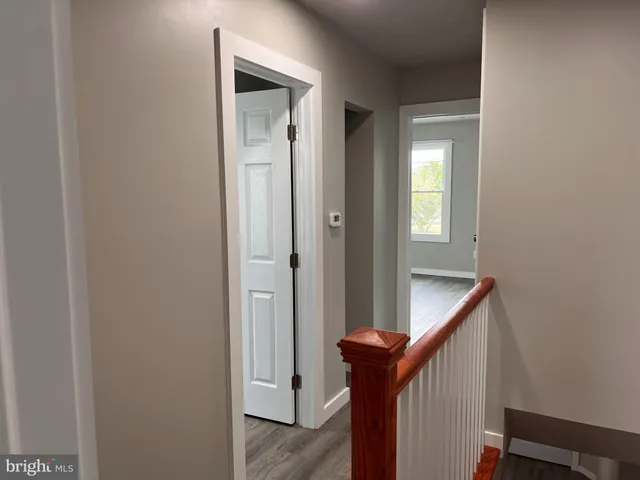 a view of an entryway with wooden floor