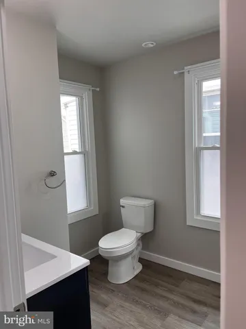 a bathroom with a toilet and a window