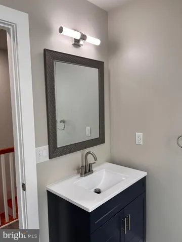 a bathroom with a sink vanity and a mirror