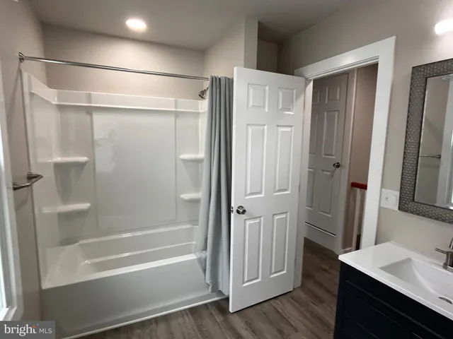 a bathroom with a shower and a tub