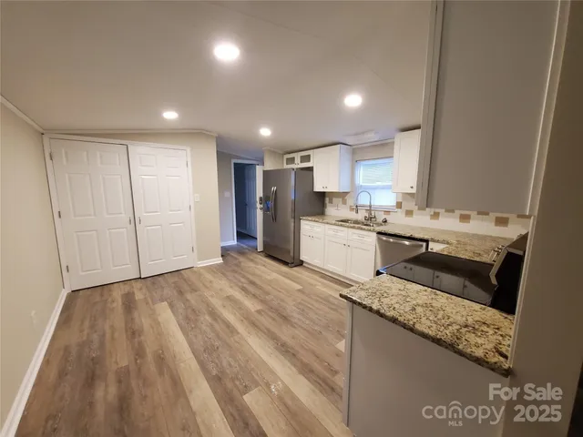 a kitchen with a sink stainless steel appliances and cabinets