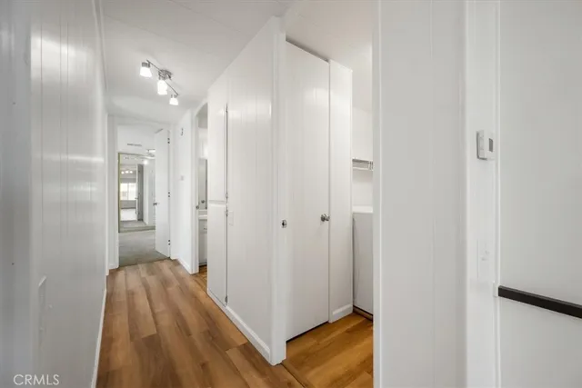 a view of a hallway with wooden floor