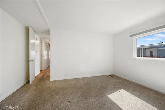 an empty room with a empty space and windows