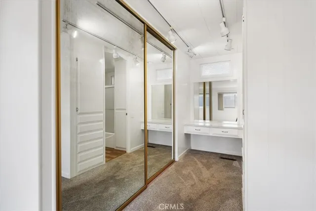 a view of bathroom with a sink and mirror