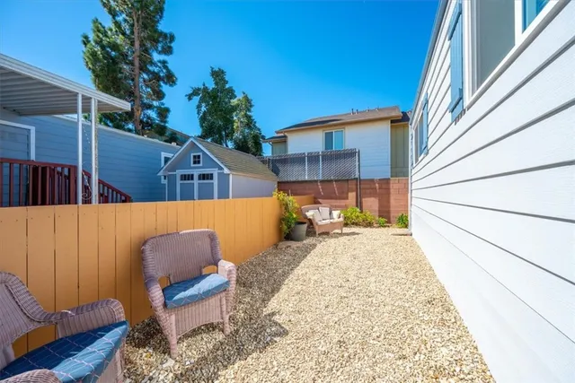 a view of a balcony with chairs and a potted plant