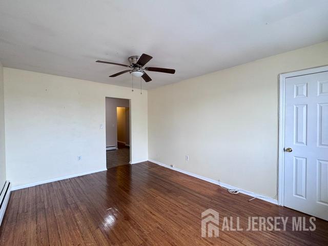 760 Mary Street, Unit B Perth Amboy, NJ 08861 - Photo 3 of 10 a view of an empty room with wooden floor