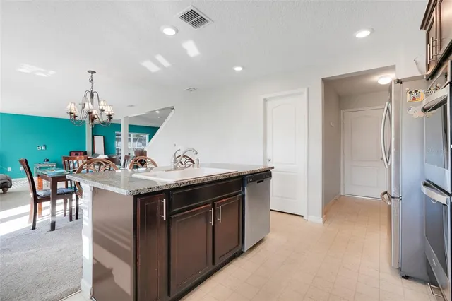 a kitchen with a sink and a refrigerator