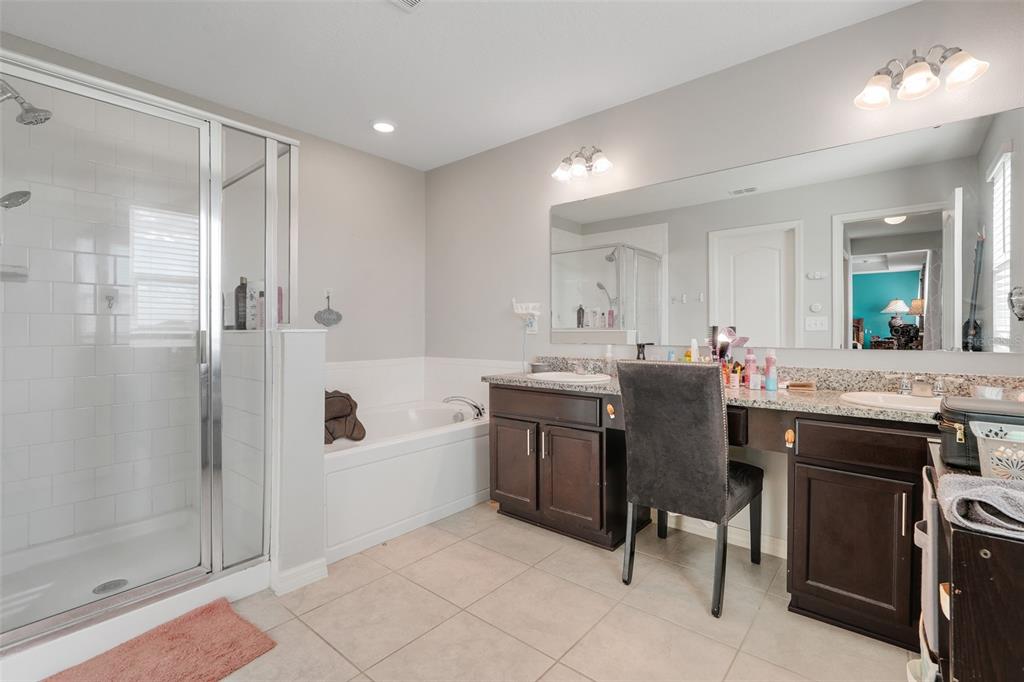 2111 Ficus Street Mascotte, FL 34753 - Photo 15 of 24 a bathroom with a sink double vanity and tub