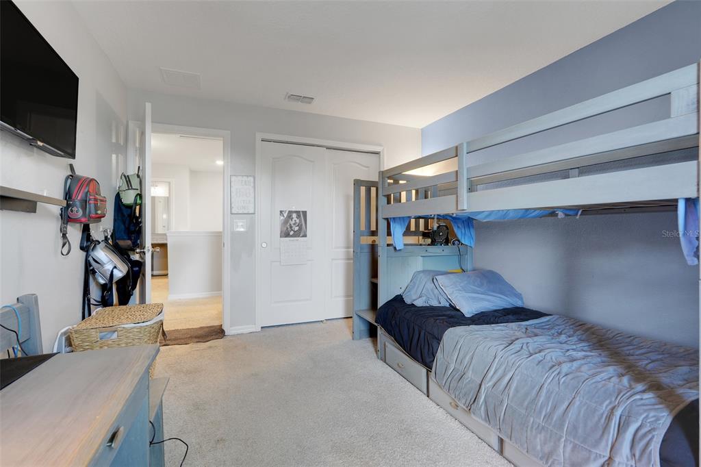 2111 Ficus Street Mascotte, FL 34753 - Photo 18 of 24 a bedroom with a bed and a flat screen tv