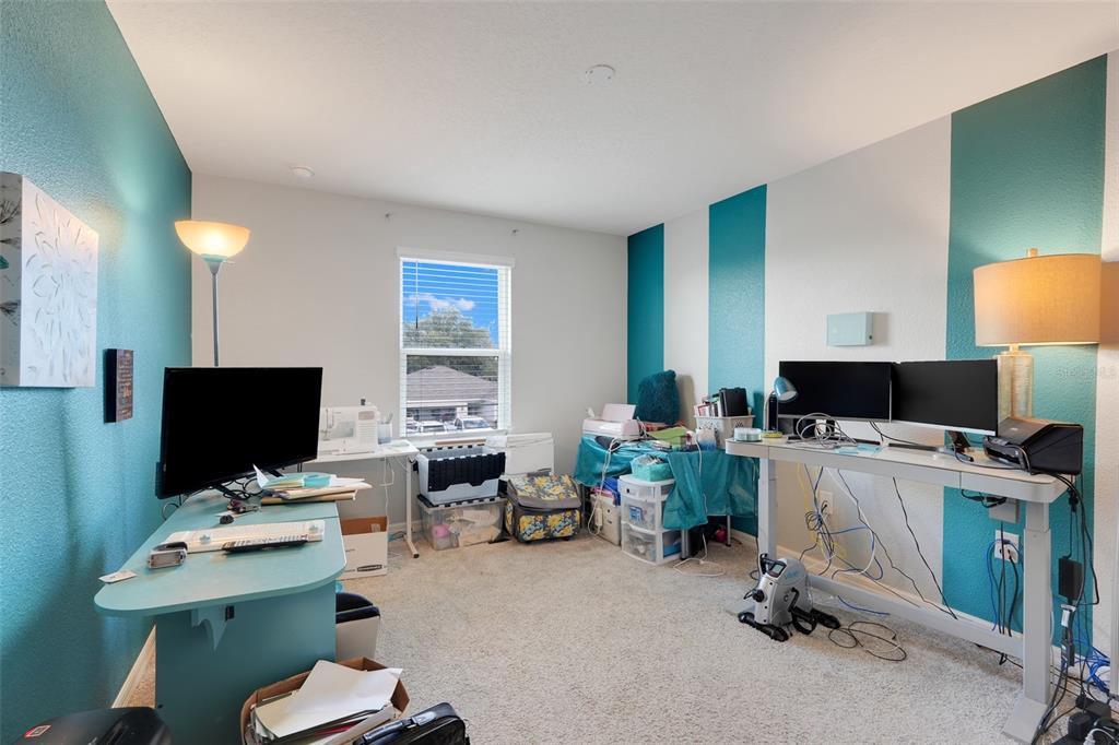 2111 Ficus Street Mascotte, FL 34753 - Photo 19 of 24 a view of a workspace with furniture and a flat screen tv