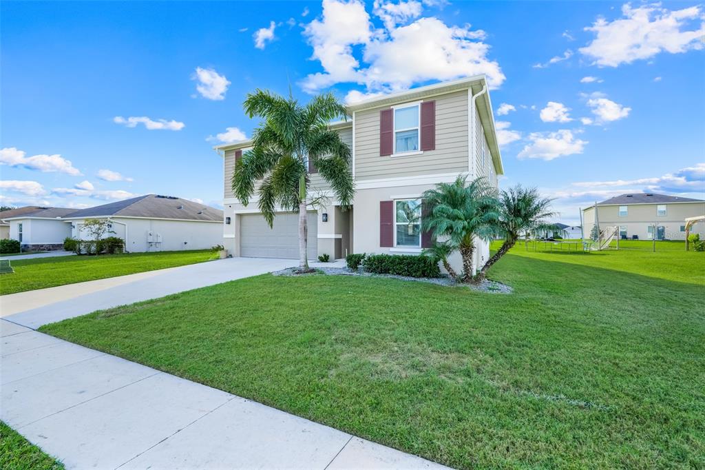 2111 Ficus Street Mascotte, FL 34753 - Photo 3 of 24 a view of a house with a backyard