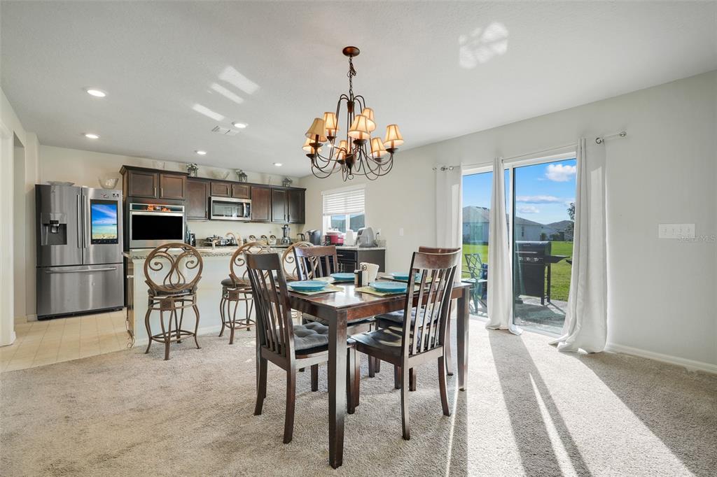 2111 Ficus Street Mascotte, FL 34753 - Photo 8 of 24 a view of a dining room with furniture and a chandelier