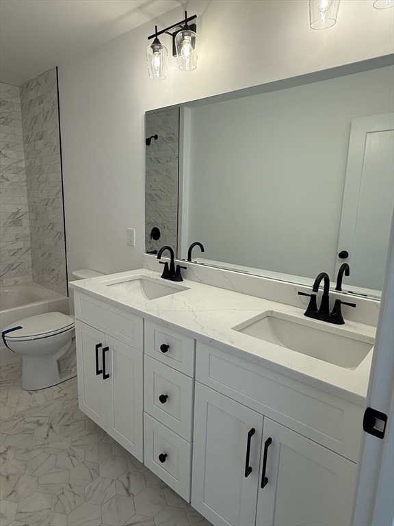 84 Pine Street Rehoboth, MA 02769 - Photo 15 of 29 a bathroom with a double vanity sink toilet and mirror
