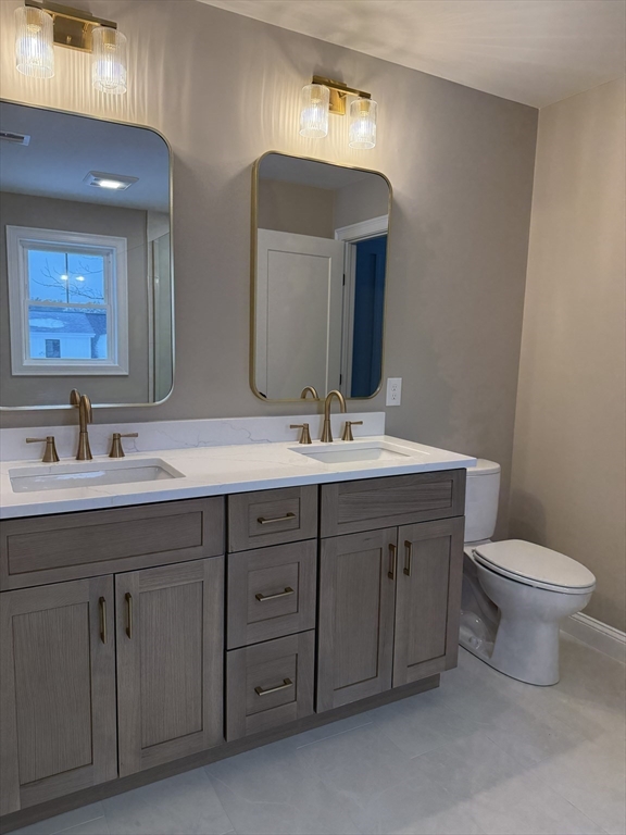 84 Pine Street Rehoboth, MA 02769 - Photo 21 of 29 a bathroom with a double vanity sink and a toilet