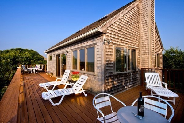 a view of a patio with chairs and potted plants