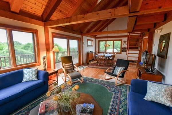 19 Lighthouse Road Aquinnah, MA 02535 - Photo 4 of 13 a living room with furniture a fireplace and large windows