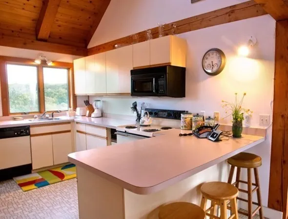 a kitchen with a table chairs and a stove