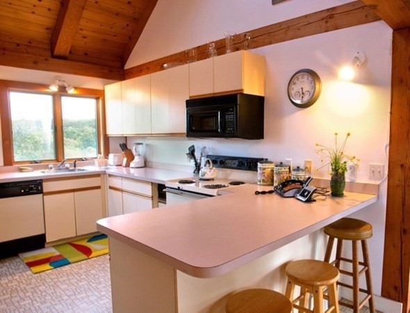 19 Lighthouse Road Aquinnah, MA 02535 - Photo 5 of 13 a kitchen with a table chairs and a stove