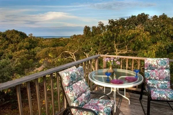 a balcony with table and chairs