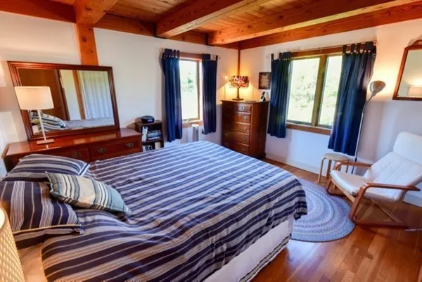 a bedroom with furniture and wooden floor