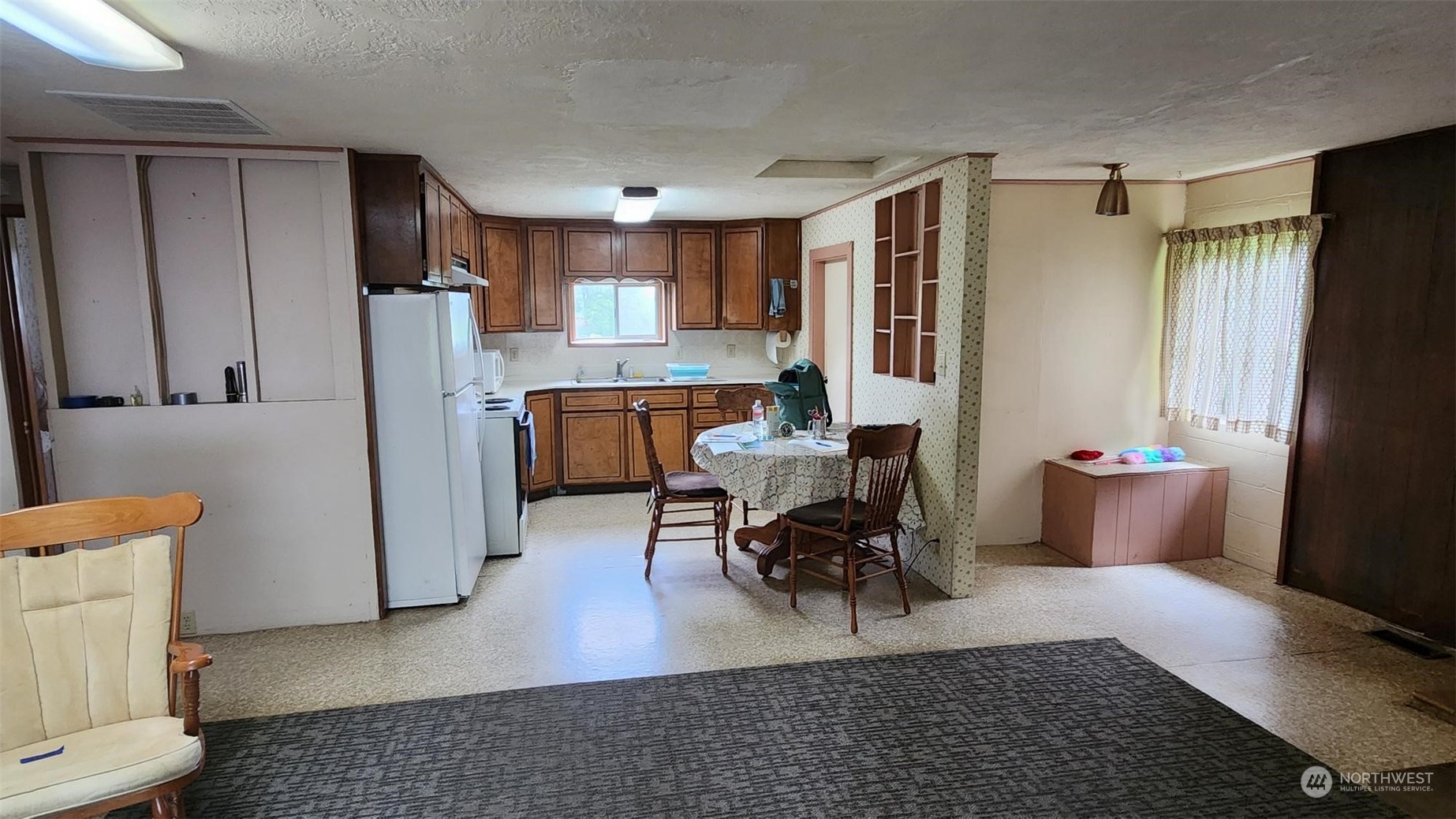 229 Rogers Road Chehalis, WA 98532 - Photo 16 of 21 a living room with furniture and a refrigerator