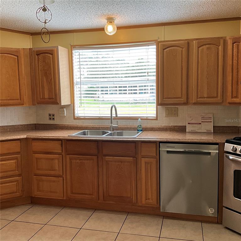 116 Traders Cove Boulevard DeBary, FL 32713 - Photo 35 of 60 a kitchen with a sink and a window