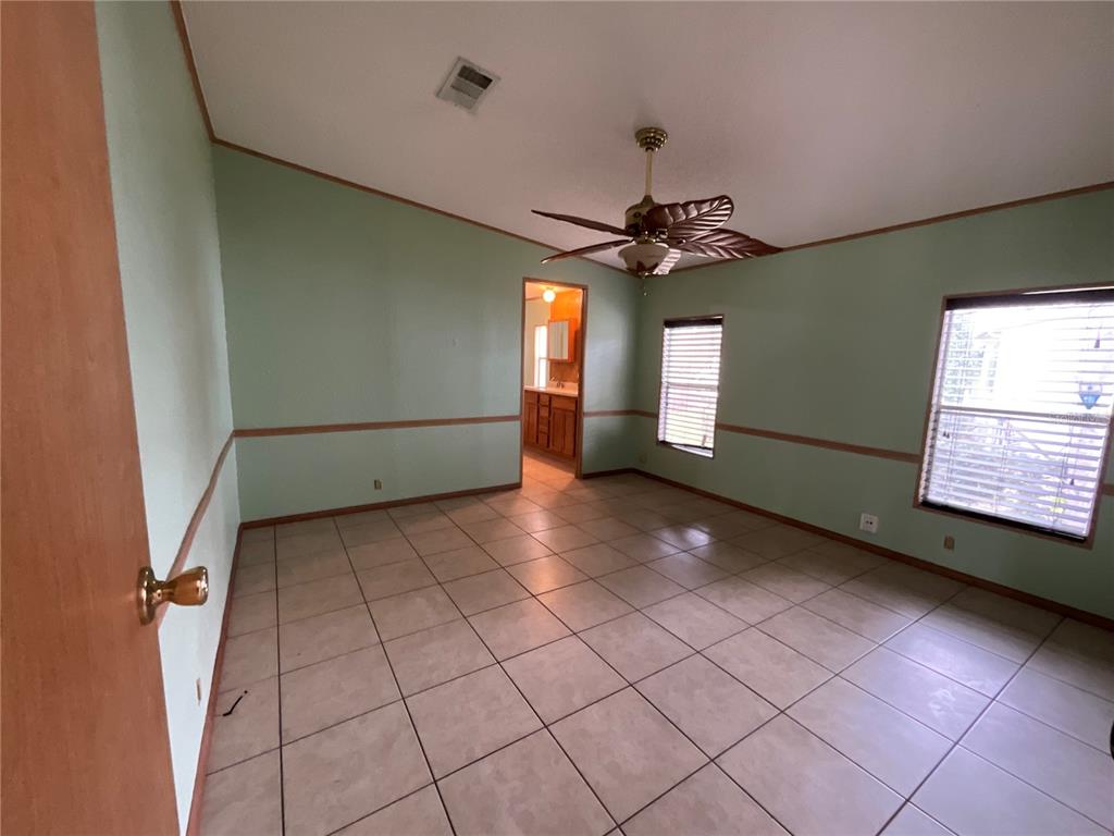116 Traders Cove Boulevard DeBary, FL 32713 - Photo 44 of 60 a view of an empty room with window and wooden floor