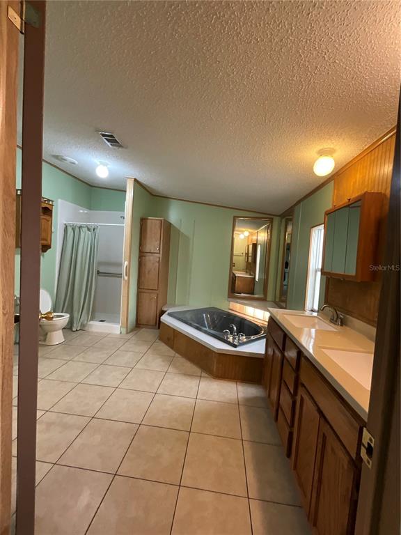 116 Traders Cove Boulevard DeBary, FL 32713 - Photo 45 of 60 a kitchen with a stove a sink and a refrigerator